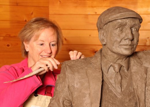 Jill Atley working on a Yorkshireman on a bench sculpture